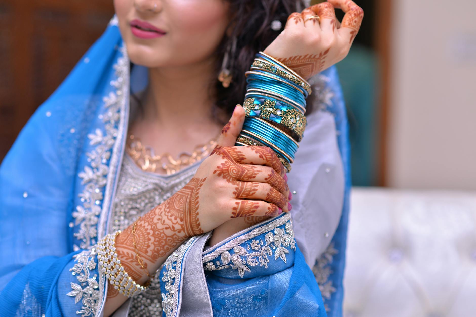 woman wearing blue traditional indian dress and silk thread bangles