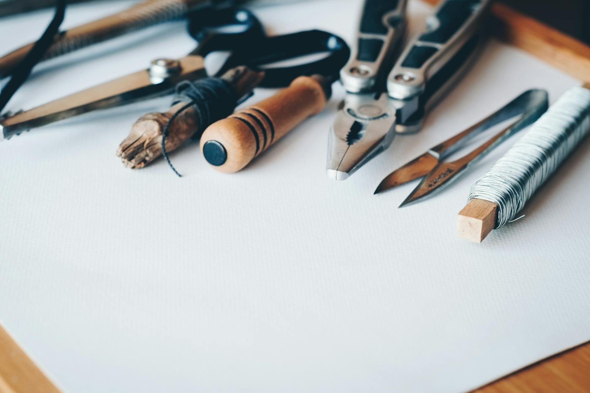 several handheld tools on white printer paper